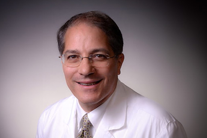 Headshot of Timothy Shapiro, MD, Interventional Cardiology Fellowship Program Director. He wears a tie, glasses, and white coat.