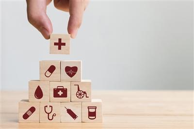Building blocks with health-related icons on them