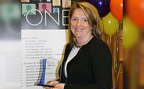Donna Phillips posing with the award
