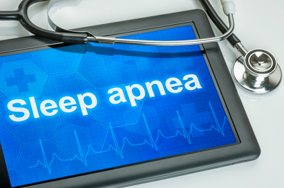 Sleep apnea written on tablet screen with stethoscope draped over the side of it