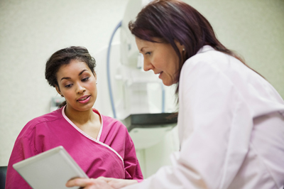 Technician with mammogram patient going over information Technician with mammogram patient going over information