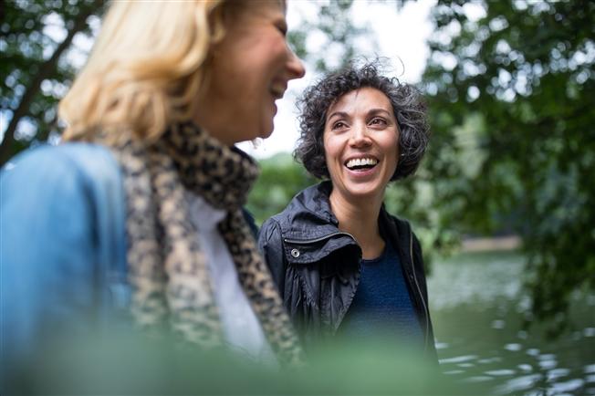 Middle-aged women talking and laughing on a walk