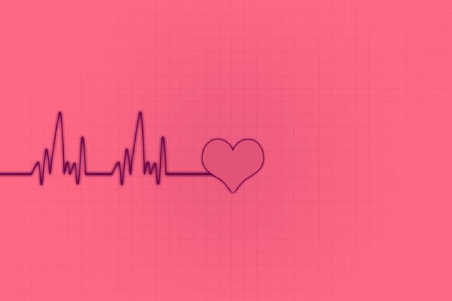 EKG leading to heart drawing on pink background