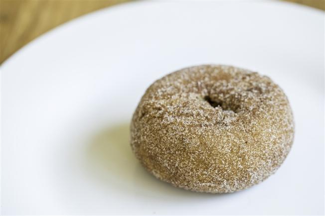 Pumpkin spiced donut on a white plate