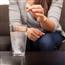 woman dropping antacid tablet into a glass of water