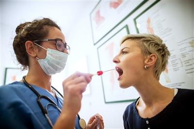 Woman getting DNA swab inside cheek