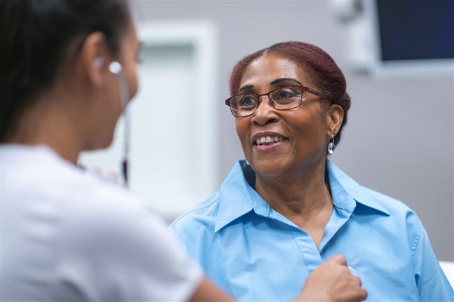 Woman talking to female physician