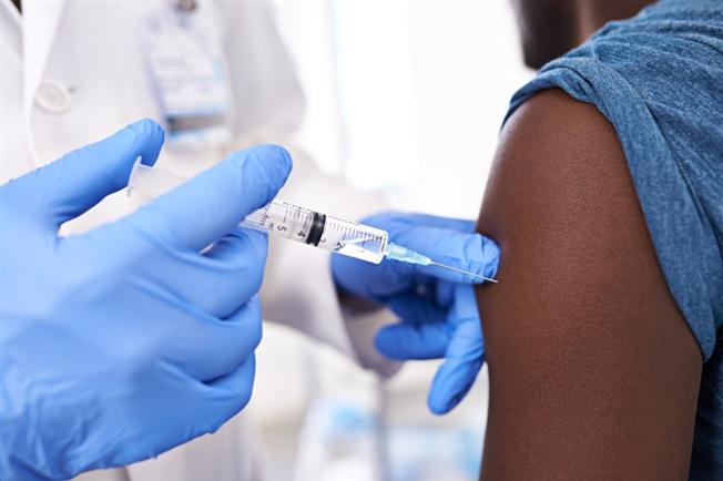 Person getting flu shot in their arm