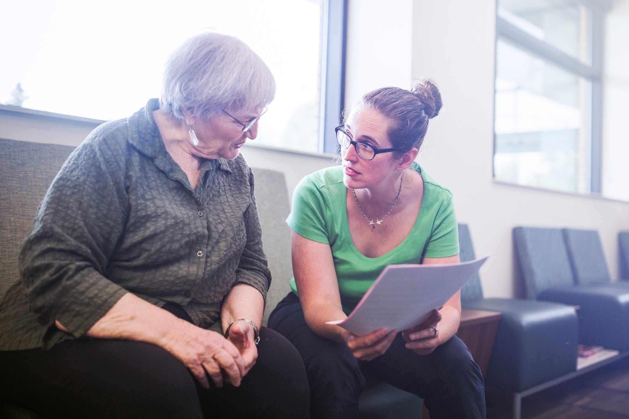 Woman talking to doctor in waiting room