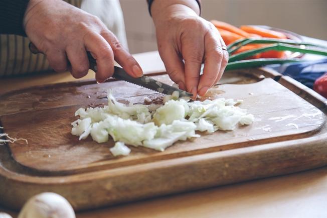 onion being diced on a cutting board