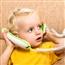 young child playing with corded phone