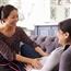 Pregnant woman being examined at home by midwife