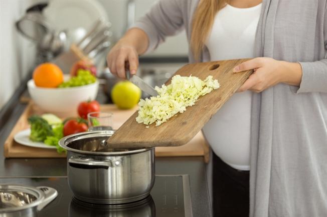 Pregnant woman cooking