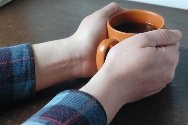 Hands around cup