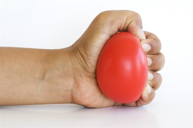 Man squeezing heart ball