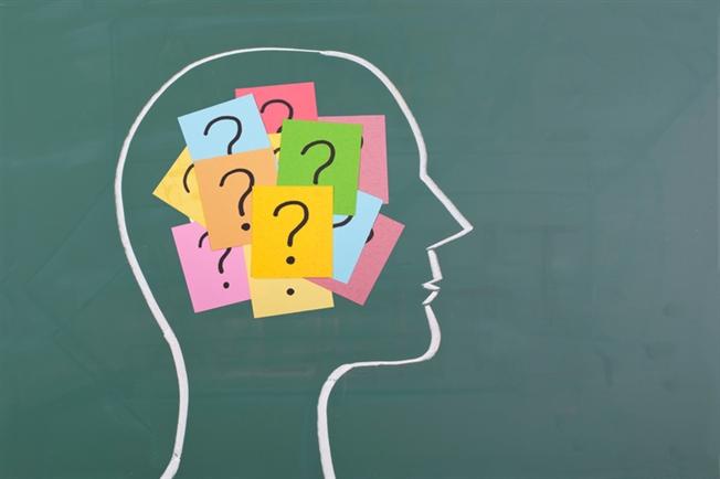 Human brain and colorful question marks Human brain and colorful question marks