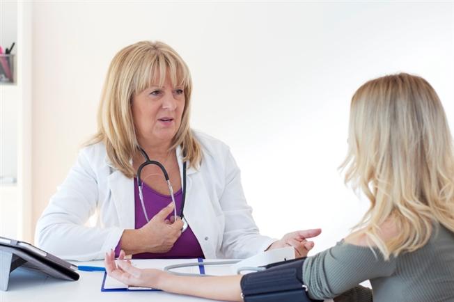 Woman getting blood pressure done at doctor's office