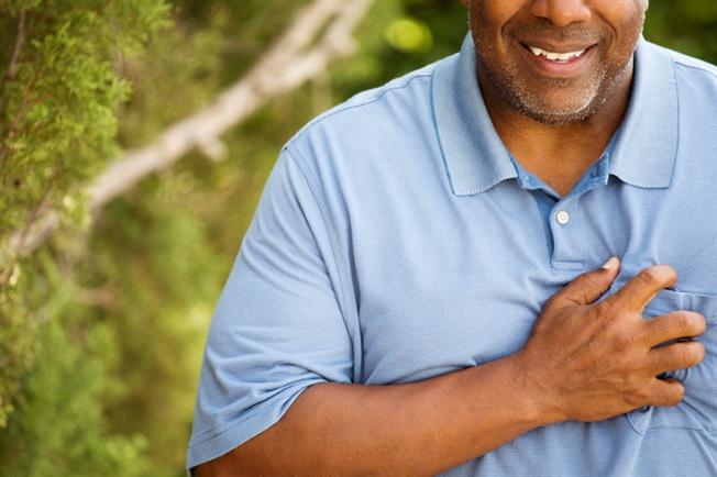 Man clutching his chest Man clutching his chest