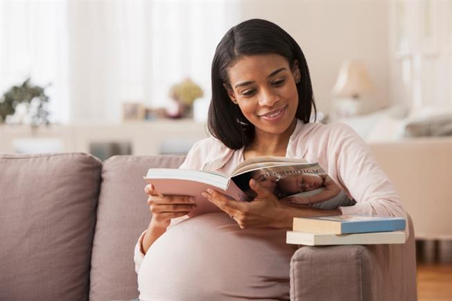 Pregnant woman reading book