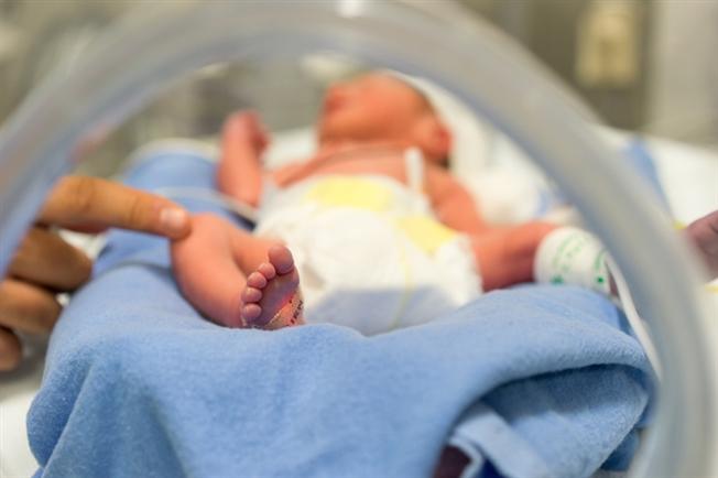Woman touching baby's foot