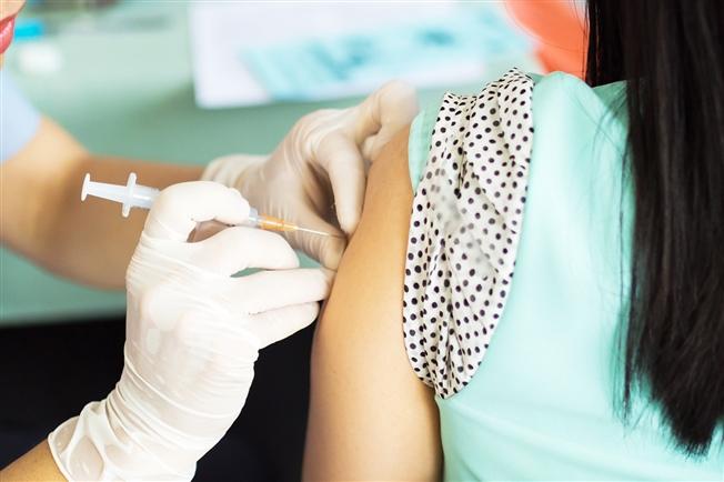 Woman getting vaccine in arm