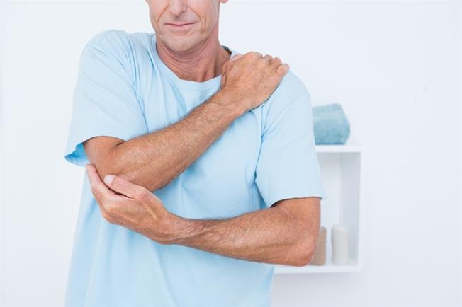 Man holding elbow Man holding elbow