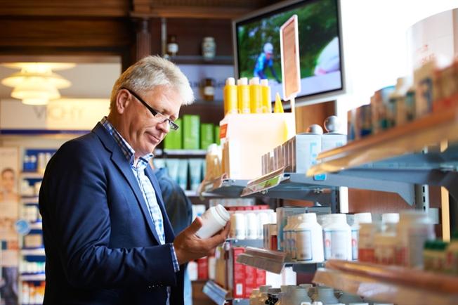 Older gentleman shopping for OTC medications Older gentleman shopping for OTC medications