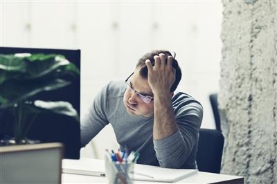 Man looking at computer stressed