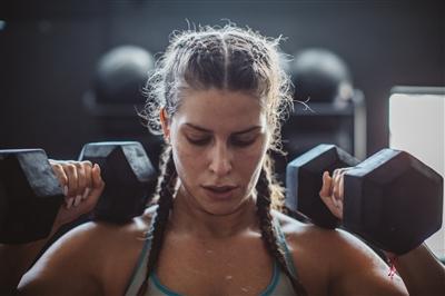 Woman working out with arm weights