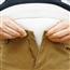 Man trying to button pants