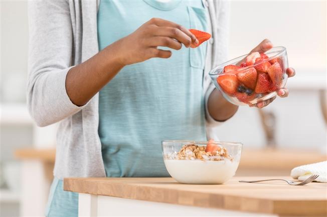 Woman eating strawberries