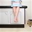 Close up on a person's legs hanging off the doctor's office table
