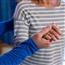 Therapist holding hand of senior patient