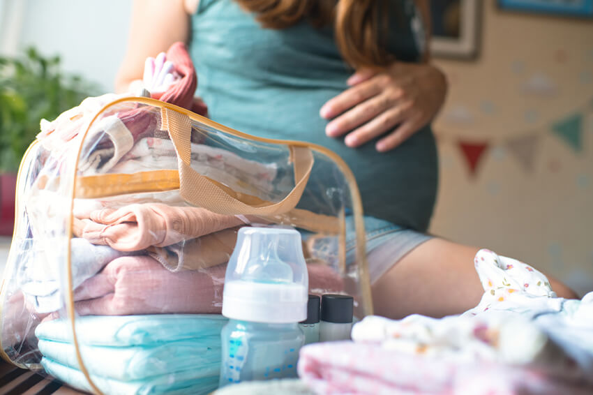 Pregnant woman packing for the hospital