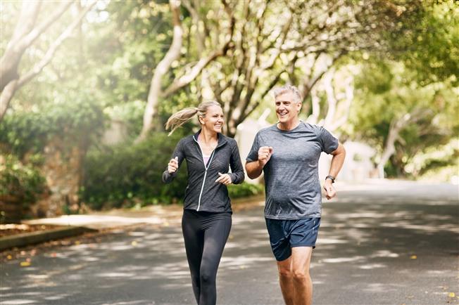 Adult couple jogging outside