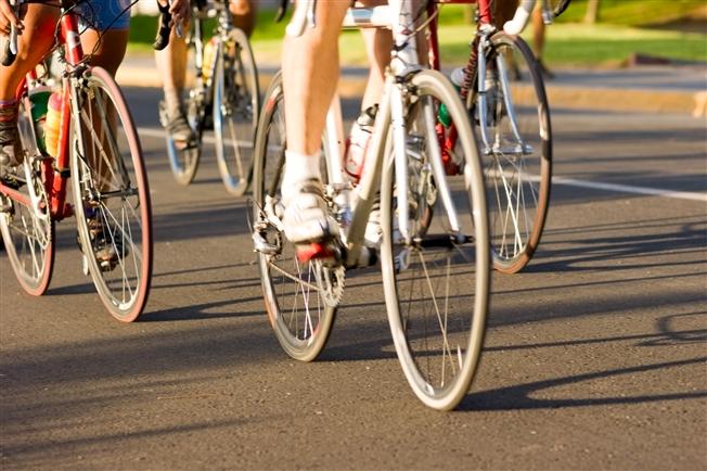 Close up on a group of bikes riding down a road