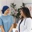 Breast cancer patient talking with doctor in hospital office setting