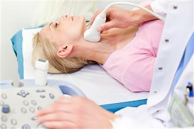Woman getting carotid artery ultrasound