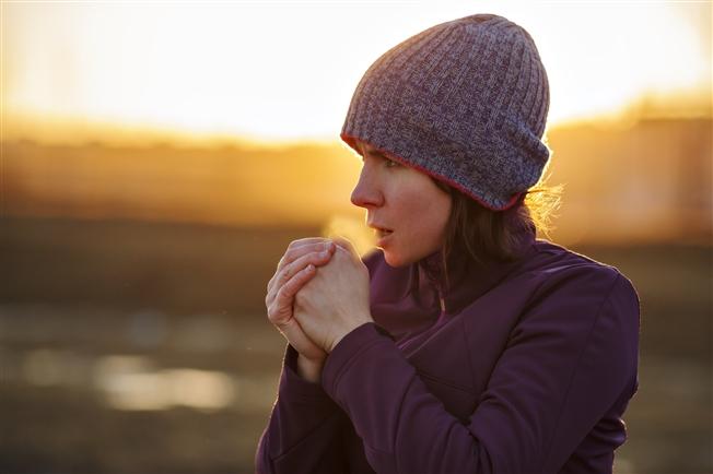 Woman breathing cold air during winter Woman breathing cold air during winter