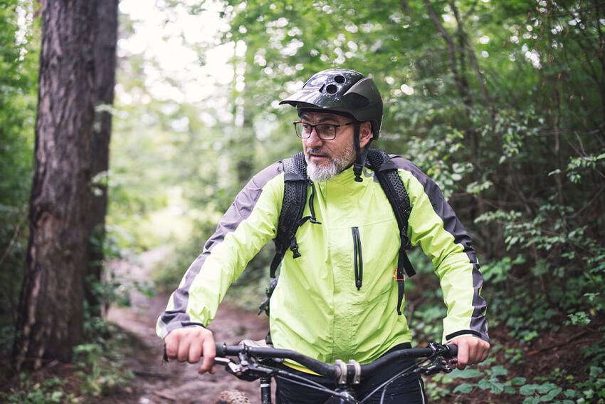 Man mountain biking in forest