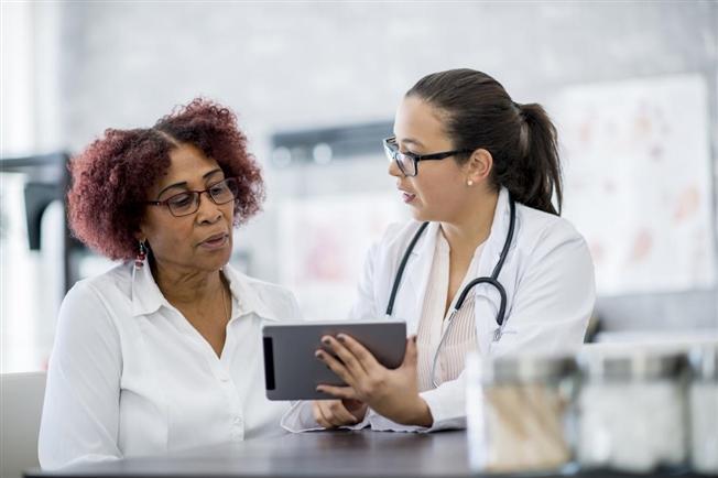 Physician working with patient to translate Physician working with patient to translate