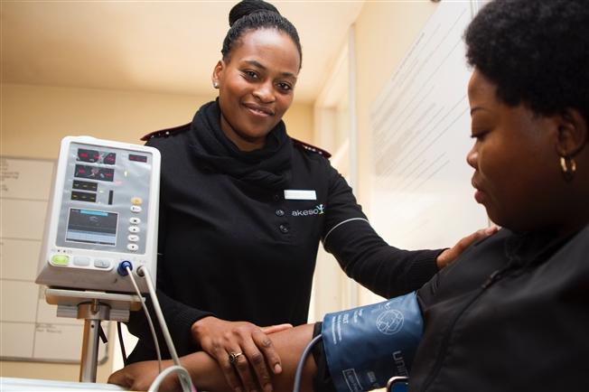 Woman taking patient's blood pressure Woman taking patient's blood pressure