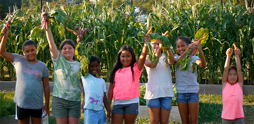 Students at Deaver Farm lifting up produce