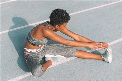 Woman stretching on track