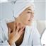 Woman examining skin in mirror