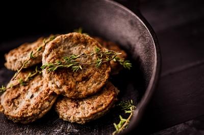 Homemade sausage in a skillet with some herbs sprinkled over it Homemade sausage in a skillet with some herbs sprinkled over it