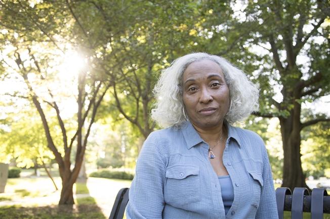 Older woman outside looking at camera with neutral expression