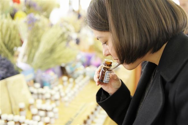 Woman smelling essential oils Woman smelling essential oils