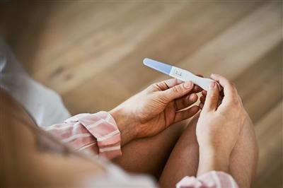 Woman looking at pregnancy test Woman looking at pregnancy test