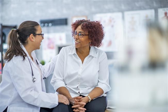 Woman talking to physician about clinical trials Woman talking to physician about clinical trials